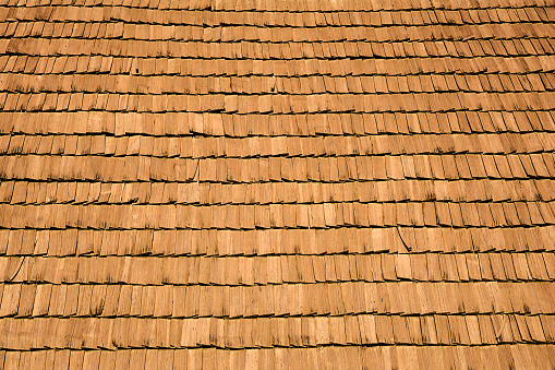 Several wood cedar shingles for siding or roofs. Brown wood roof shingles