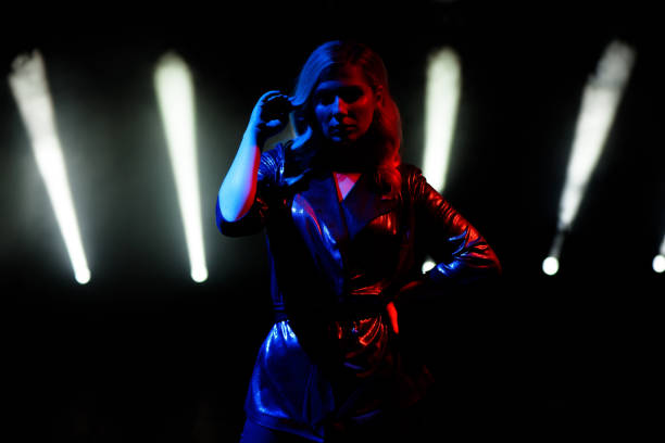 istock Singer standing on the stage in the night club. 1278304209
