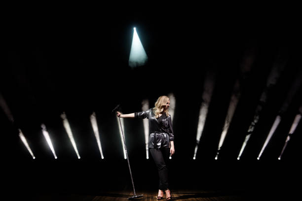 istock Singer on scene in the club. Bright stage lighting. 1278304234