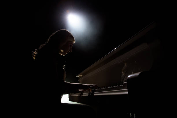 istock Female keyboards player on stage during concert, backlight 1278304292