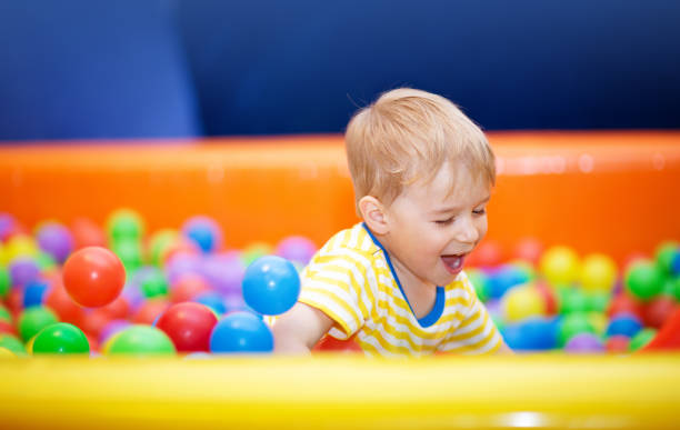 istock Little boy playing on playroom with ball pit 1278306074