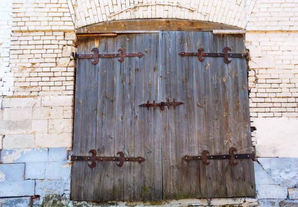 istock Old wooden gate with forged metal hinges 1278306437