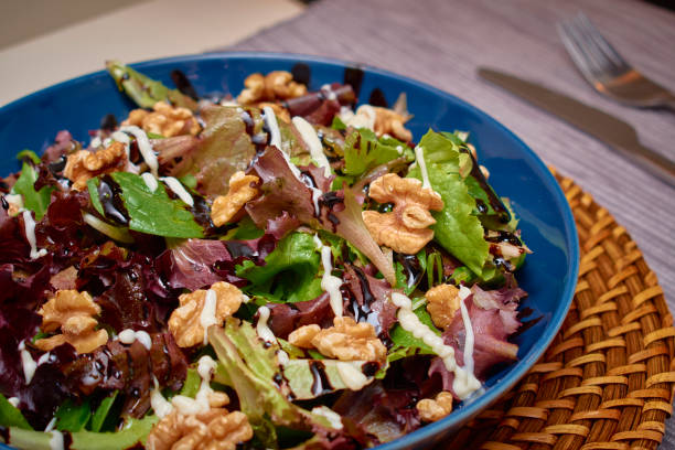 istock Vegan Mediterranean salad, with a mixture of lettuce, walnuts, balsamic vinegar, extra virgin olive oil, salt and mayonnaise 1278308677