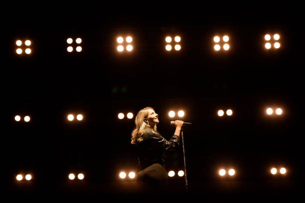 istock Singer on scene in the club. Bright stage lighting. 1278308835