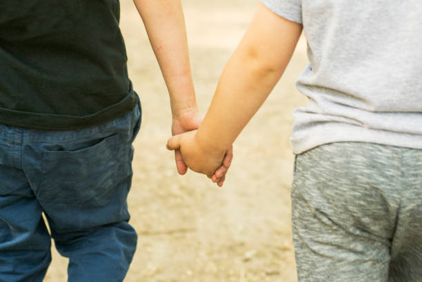 istock Brothers hold each other's hands. Friends hold each other's hands. Support and assistance 1278309603