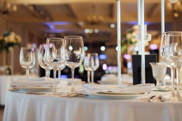istock Luxurious restaurant. Luxurious interior, white tables, serving dishes and glasses for guests 1278312814