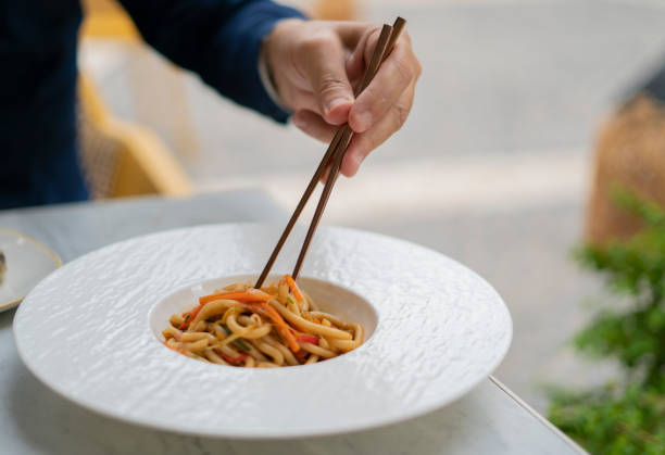 istock human hand which raises the udon to the vegetables with chopsticks 1278314565