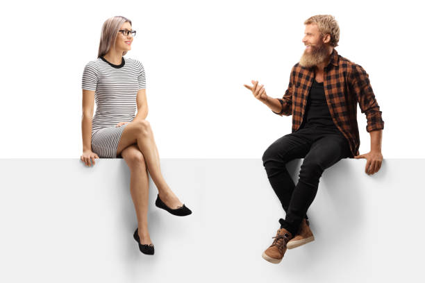 istock Bearded man with moustaches sitting on a white panel and talking to a young woman 1278317072
