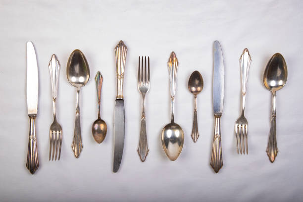 istock silver cutlery on a white tablecloth, forks, knives and spoons 1278317955