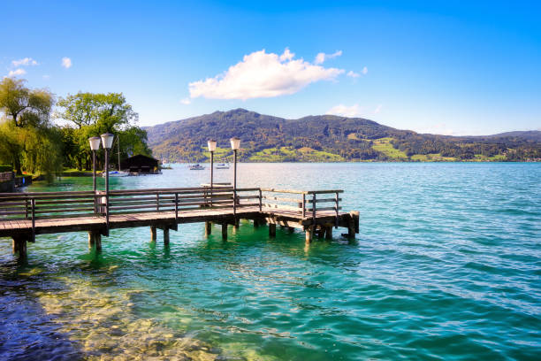 Countryside view on Attersee lake im Salzkammergut alps mountains by in Weissenbach Countryside view on Attersee lake im Salzkammergut alps mountains by in Weissenbach, Zell am Attersee. Upper Austria, nearby Salzburg. attersee stock pictures, royalty-free photos & images