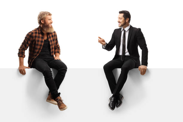 istock Businessman seated on a white panel talking to a casual guy with beard and moustaches 1278318319