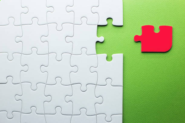 istock white puzzle with a red piece that does not fit on a green background 1278321203