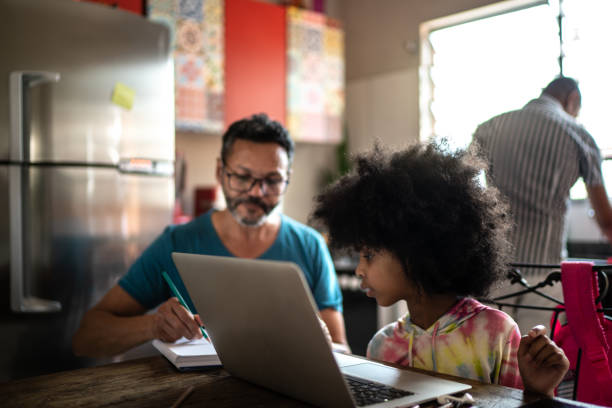 istock Father helping daughter with homework at home 1278322367