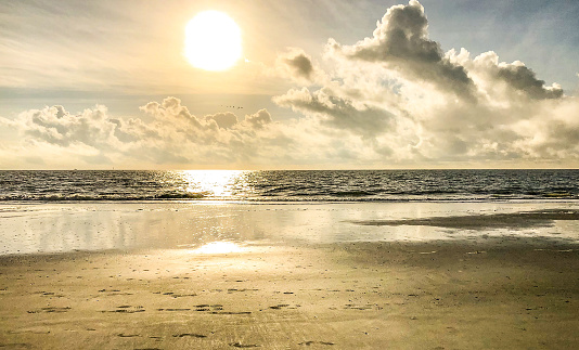 The sun rises above the Atlantic Ocean. Views from the shore of Tybee Island, Georgia offers a sense of peace and tranquility.