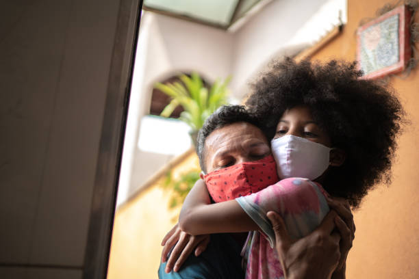 istock Girl using face mask going to / arriving from school and embracing father 1278322960