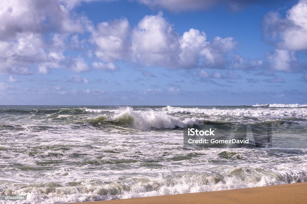Turbulent Ocean Waves On Beach Off California Coast Turbulent ocean waves crashing on sandy beach, off the California Coast, after a pacific coast storm passed through the area.

Taken at Davenport Landing, California, USA Beach Stock Photo