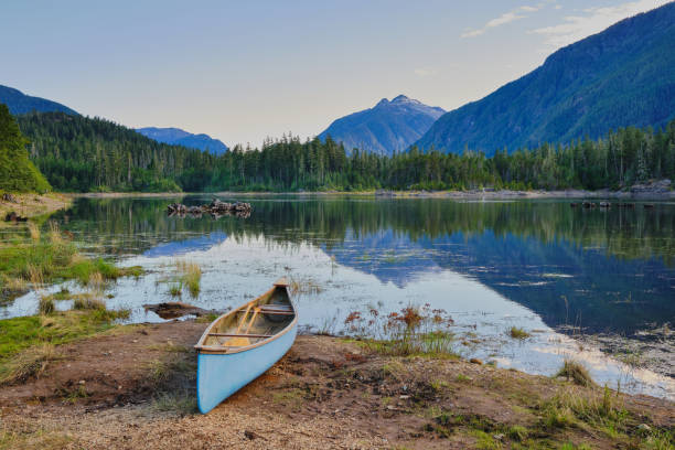 istock Blue canoe beside blue Buttle lake and blue mountains, BC 1278324103