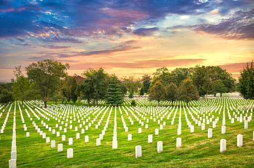 Grave stones at Arlington National Cemetery in Washington DC at sunset.