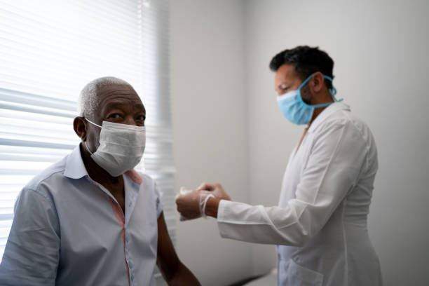 istock Portrait of patient getting vaccination using face mask 1278324385