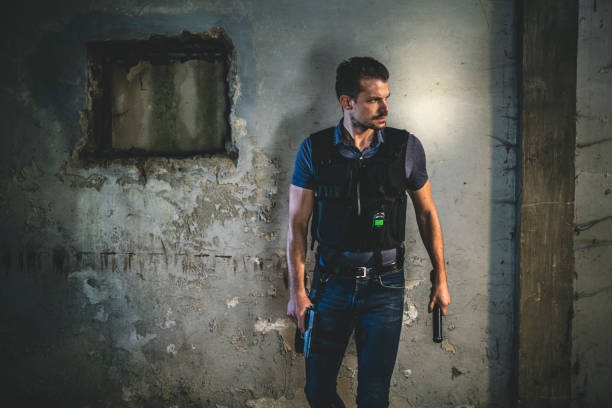 istock Police Officer Standing in Run-Down Urban Setting at Night 1278329818