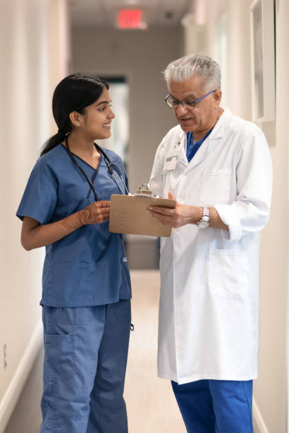 istock Doctor and nurse discussing in the hallway 1278330225