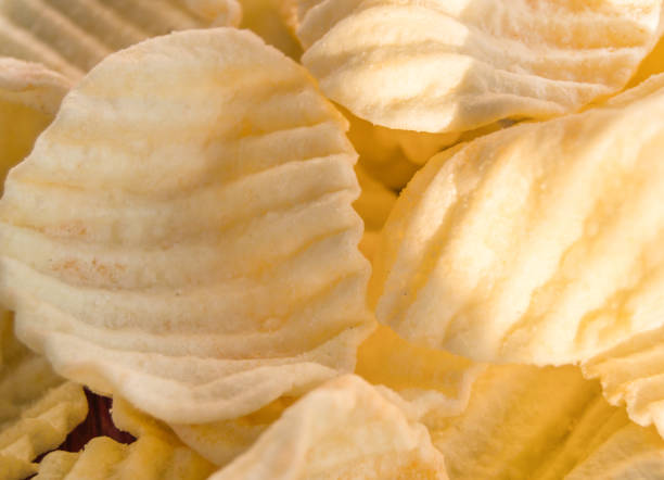 istock Yellow delicious salty potato chips in the background 1278330462
