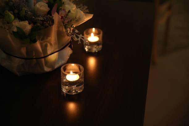istock Two candles by the dark indoor flower basket 1278336266