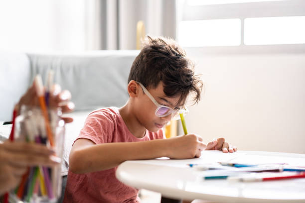 istock Child drawing with colorful pencils at home 1278338604