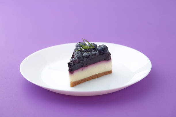 istock blueberry cheesecake on white plate on violet background 1278347680