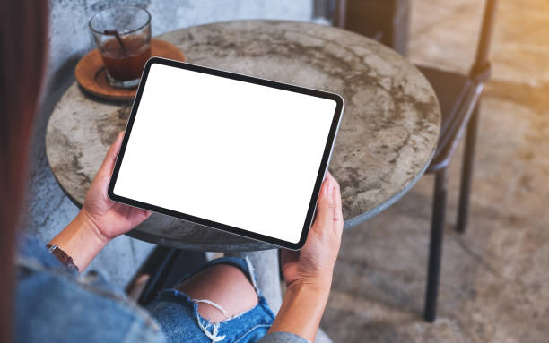 istock a woman holding digital tablet with blank white desktop screen 1278354301