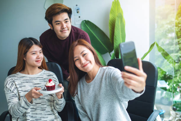 istock Group of young people using mobile phone to take a selfie 1278354322