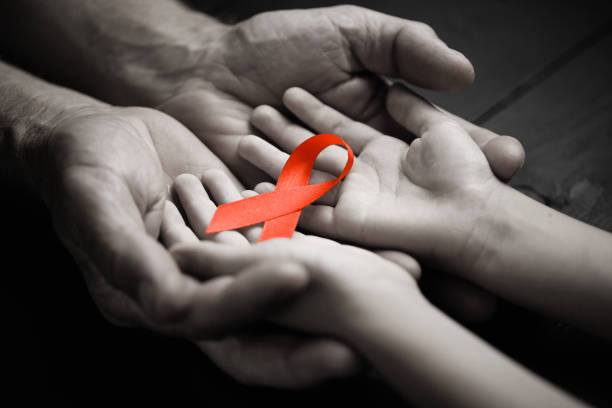 istock AID red ribbon in hand 1278357860