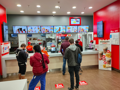 Kyiv, Ukraine - September 6, 2020: KFC Fast Food Meal. Worldwide Famous American Restaurant at Kyiv, Ukraine on September 6, 2020. Safety measures against corona virus. Covid 19 protection. Ways to secure social distancing in restourant
