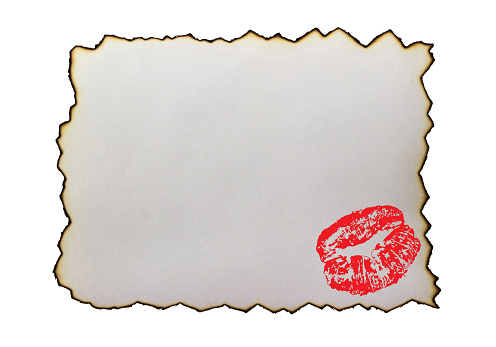 Burnt paper with kiss (imprint of red lipstick), isolated. Love letter or message.