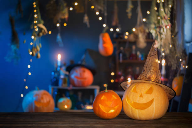 istock Halloween pumpkins on old wooden table on background Halloween decorations 1278358024