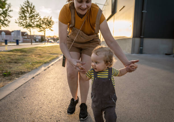 istock Baby boy taking first steps outdoors 1278360127
