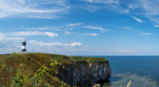 istock Panoramic view of lighthouse at Cape Notoro with clear blue sky 1278362859