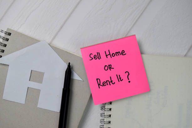 istock Sell Home or Rent it? text write on sticky notes isolated on office desk. 1278365381