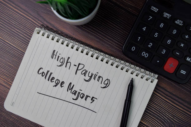 istock High-Paying College Majors text write on a book isolated wooden table. 1278366040