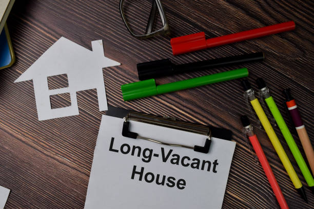istock Long-Vacant House text write on paperwork isolated on office desk. 1278366200
