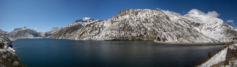 A panoramic view of Lake Alta with clouds over it in winter in Queenstown, New Zealand.