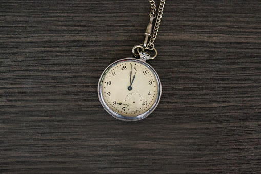 Vintage Pocket watch with shadow isolated on white background. Concept of direction and orientation