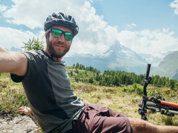 istock Mountain biker takes selfie with Matterhorn mountain 1278373754