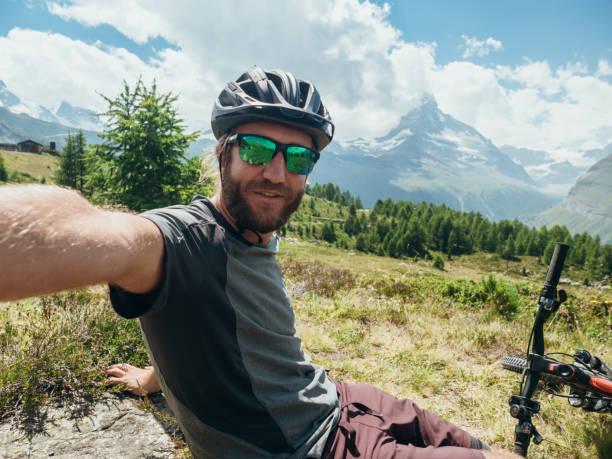 istock Mountain biker takes selfie with Matterhorn mountain 1278373841