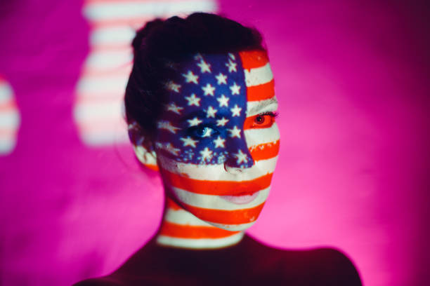 istock Young woman with USA flag on her face 1278379321