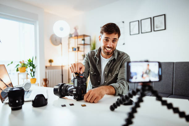 istock Vlogger examining memory cards for cameras - man looking into mobile phone while recording himself 1278379330