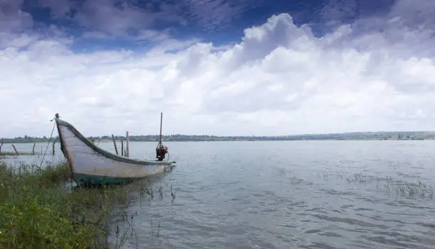 A Beautiful Landscape Picture of the famous Kabini Backwaters with an Abandoned Boat and the Cloudscape near Mysuru in Karnataka/India.