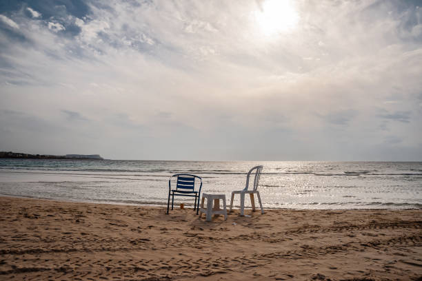 istock Chairs on the sandy seashore against the sky 1278386018