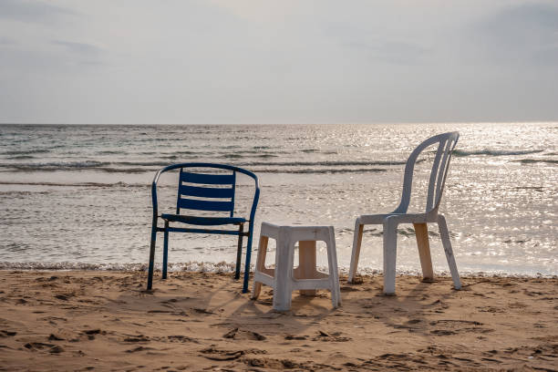 istock Chairs on the sandy seashore against the sky 1278386019