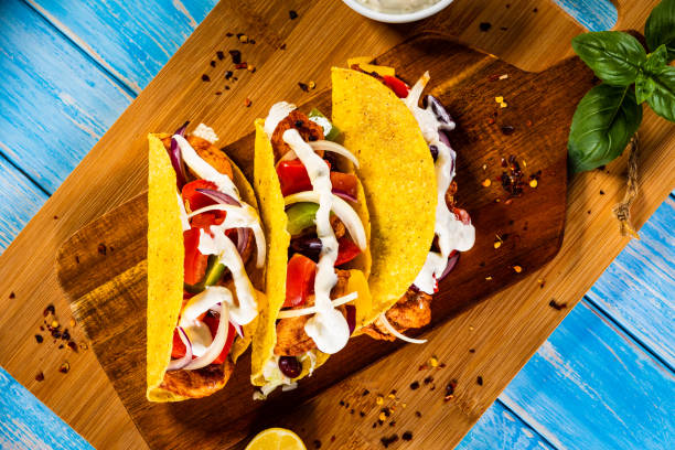 istock Tacos on cutting board on wooden table 1278387418
